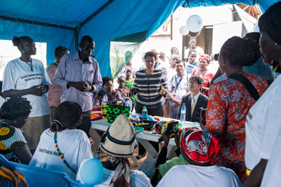 The Executive Director addresses the women who have gathered for the visit.