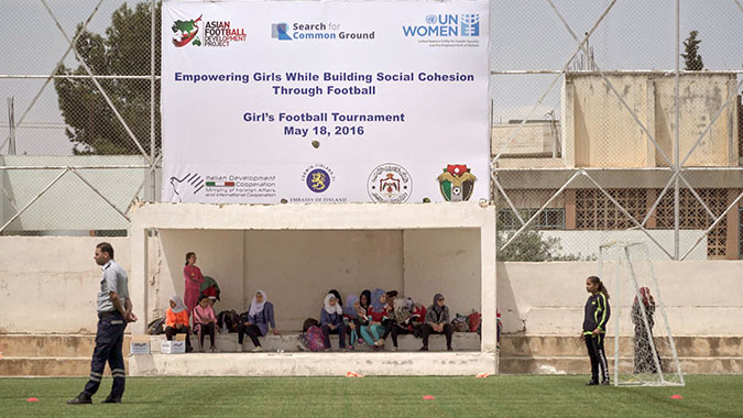 Syrian refugee and Jordanian girls practice football and become friends in Jordan. Photo: UN Women/Christopher Herwig