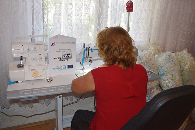 A survivor of conflict-related sexual violence in Kosovo works on pillow production, after receiving a micro-grant. Photo: Dorina Babuni