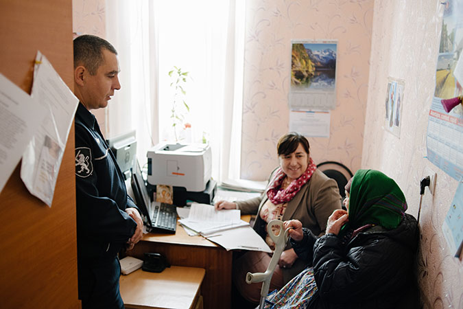 ogether with the local social assistant, police officer Victor Zglavoci talks to an elderly woman from the village, Colibasi, Moldova. Photo: UN Women/Ramin Mazur