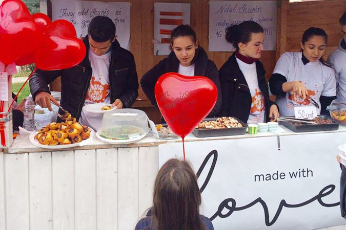 Members of the Made with Love team sell baked goods made by survivors of violence. UN Women/ Ina Cenko