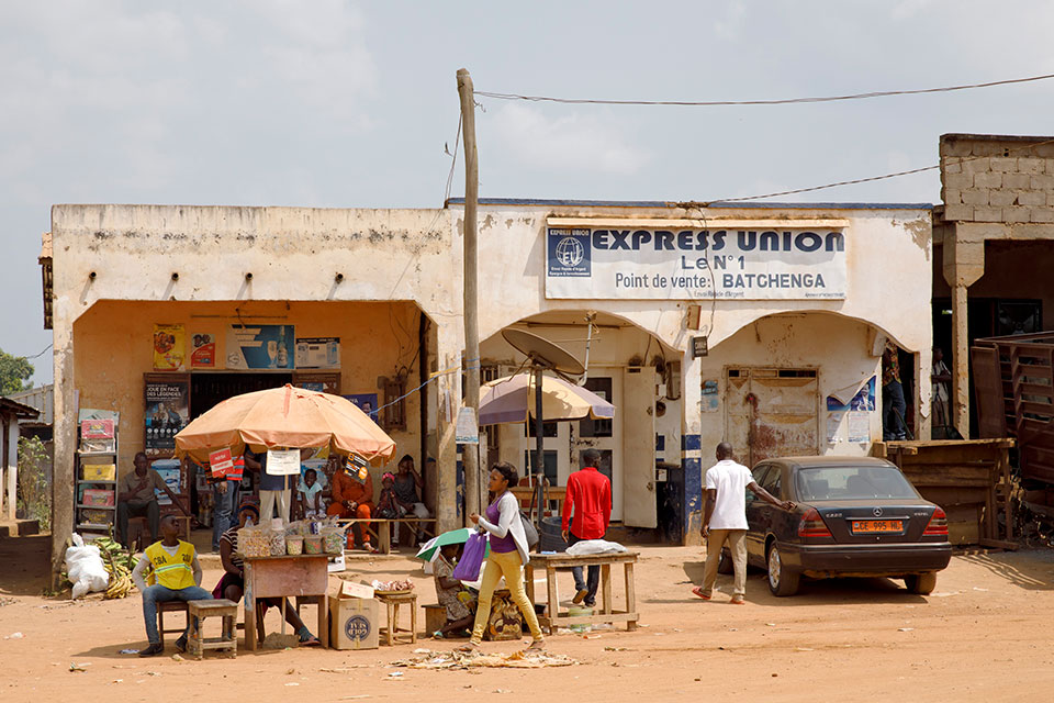 Streetside “call box” stands along one of the main intersections in Batchenga. When travelling north from the capital, Yaounde, Batchenga currently represents the end of the paved highway. Photo: UN Women/Ryan Brown