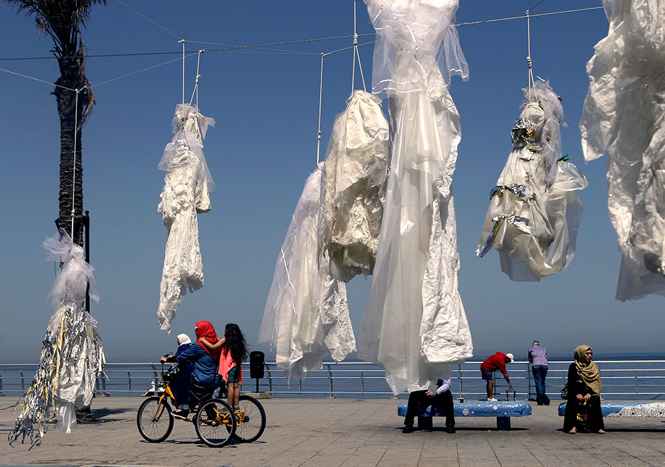 In Lebanon, activists hung tattered wedding dresses outside public buildings in order to draw attention to laws that forced women to marry their rapists. Photo: ABAAD by Patrick Baz /AFP