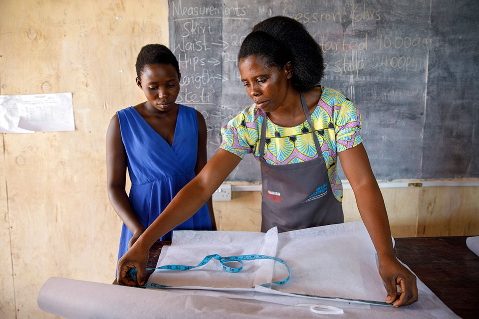 Beatrice Silas Kasiba scored top marks in the national Trade Certificate exam and now teaches tailoring to other refugee women and Kenyan women living in Kalobeyei settlement at a facility run by the Danish Refugee Council. Photo: UN Women/Ryan Brown