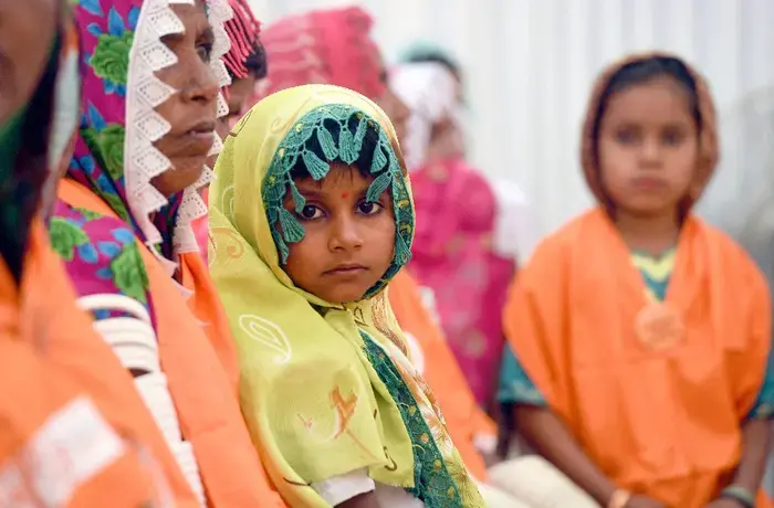 A child looks at the camera during a UN Women event in Pakistan
