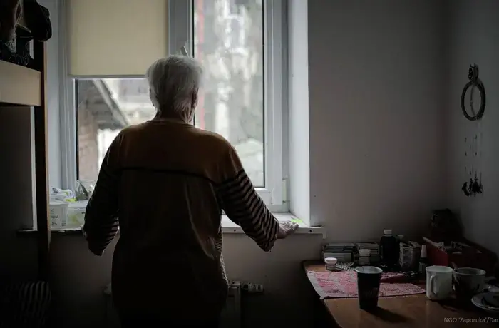 In the Lviv region of Ukraine a woman stands in her room in a shelter of NGO ‘Zaporuka’ for survivors of gender-based violence