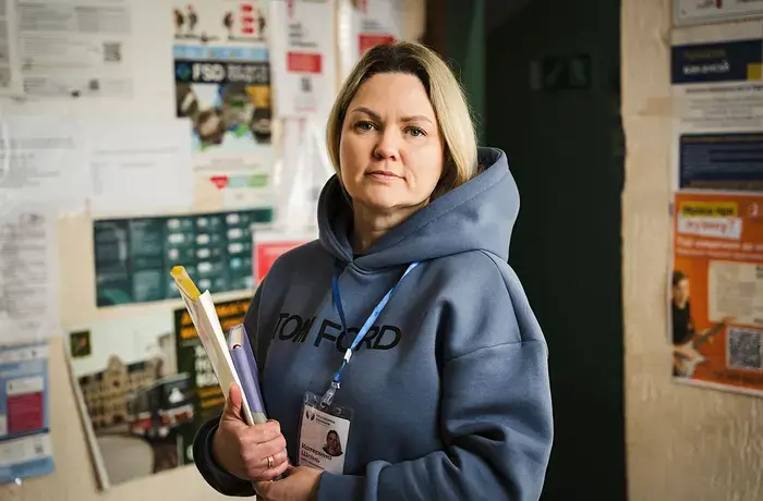 A Ukrainian woman, who works with displaced women, poses for a portrait