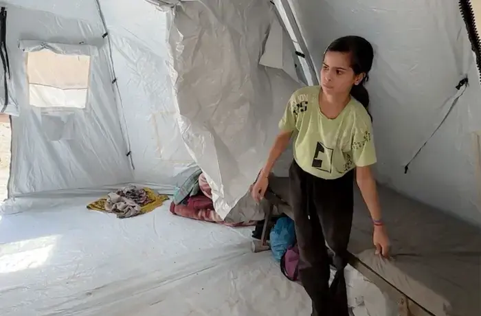 Young girl inside a tent. 