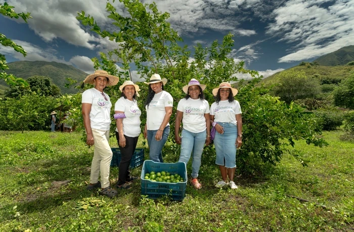 A group of women lime farmers stand proudly for a group photo