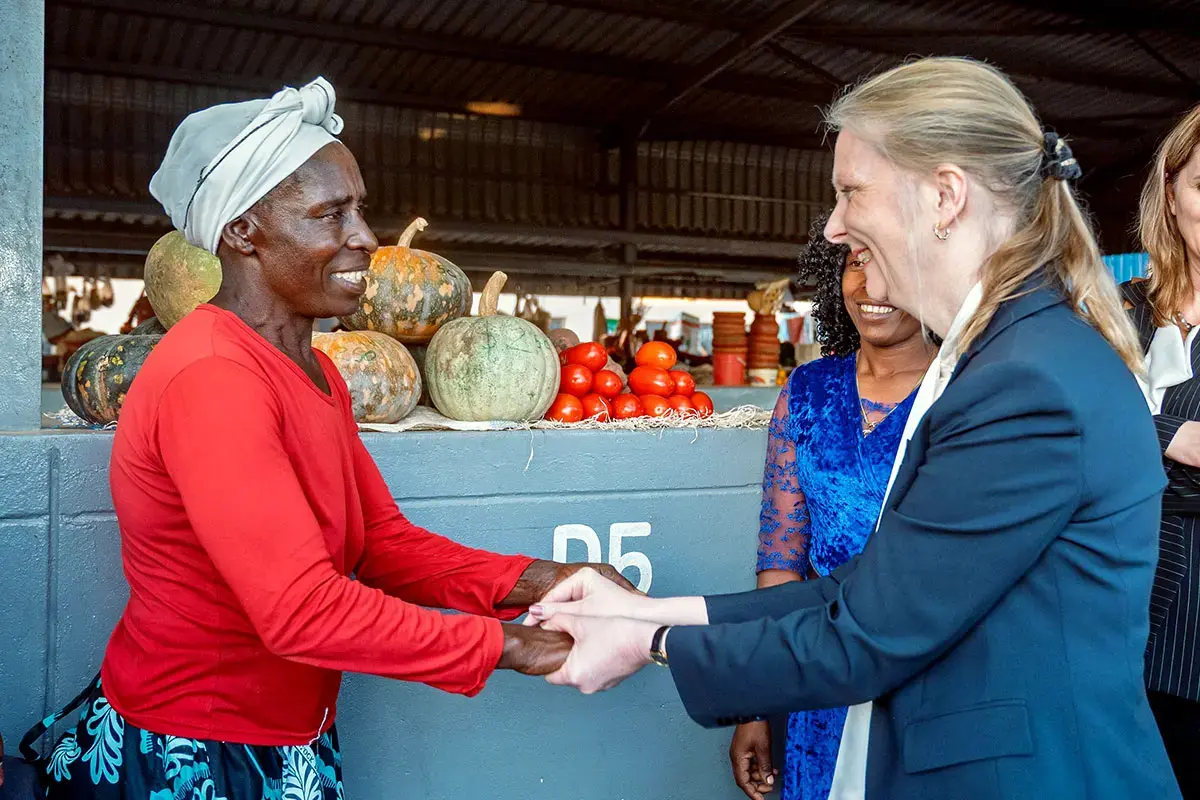A vendor from the Epworth Safe Market greets UN Women Executive Board President Clase