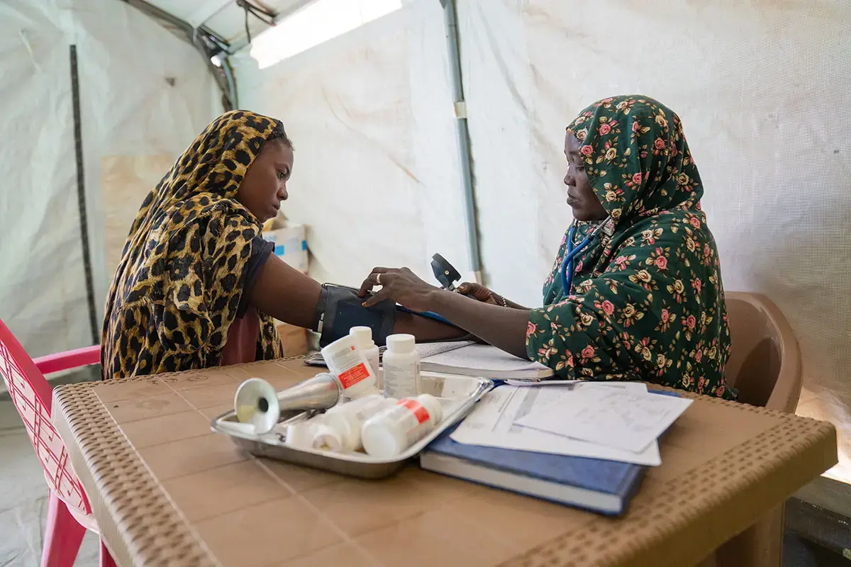 Amina, a midwife, attends to mothers at a UNICEF-supported health facility in Tawila, North Darfur.