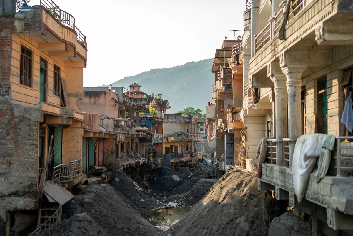 A street lined with buildings, rendered unrecognizable by mud and destruction