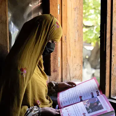 Women learn to read and write through a literacy initiative supported by UN Women, in Nuristan province, eastern Afghanistan