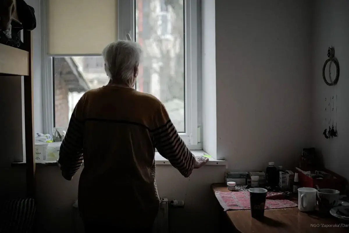 In the Lviv region of Ukraine a woman stands in her room in a shelter of NGO ‘Zaporuka’ for survivors of gender-based violence
