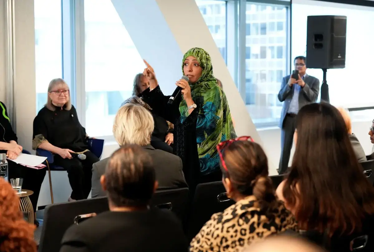 A woman speaks to an audience