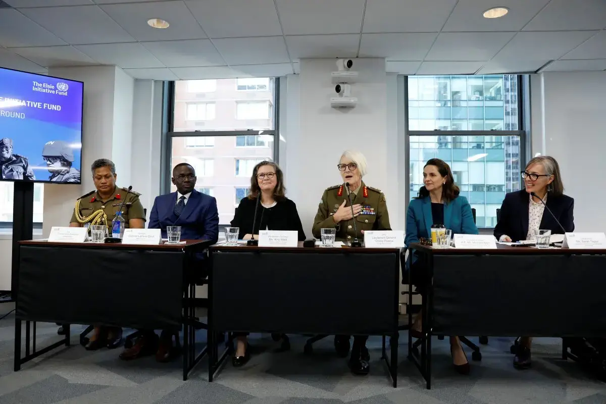 Six people, including some in military uniforms, speak on a panel