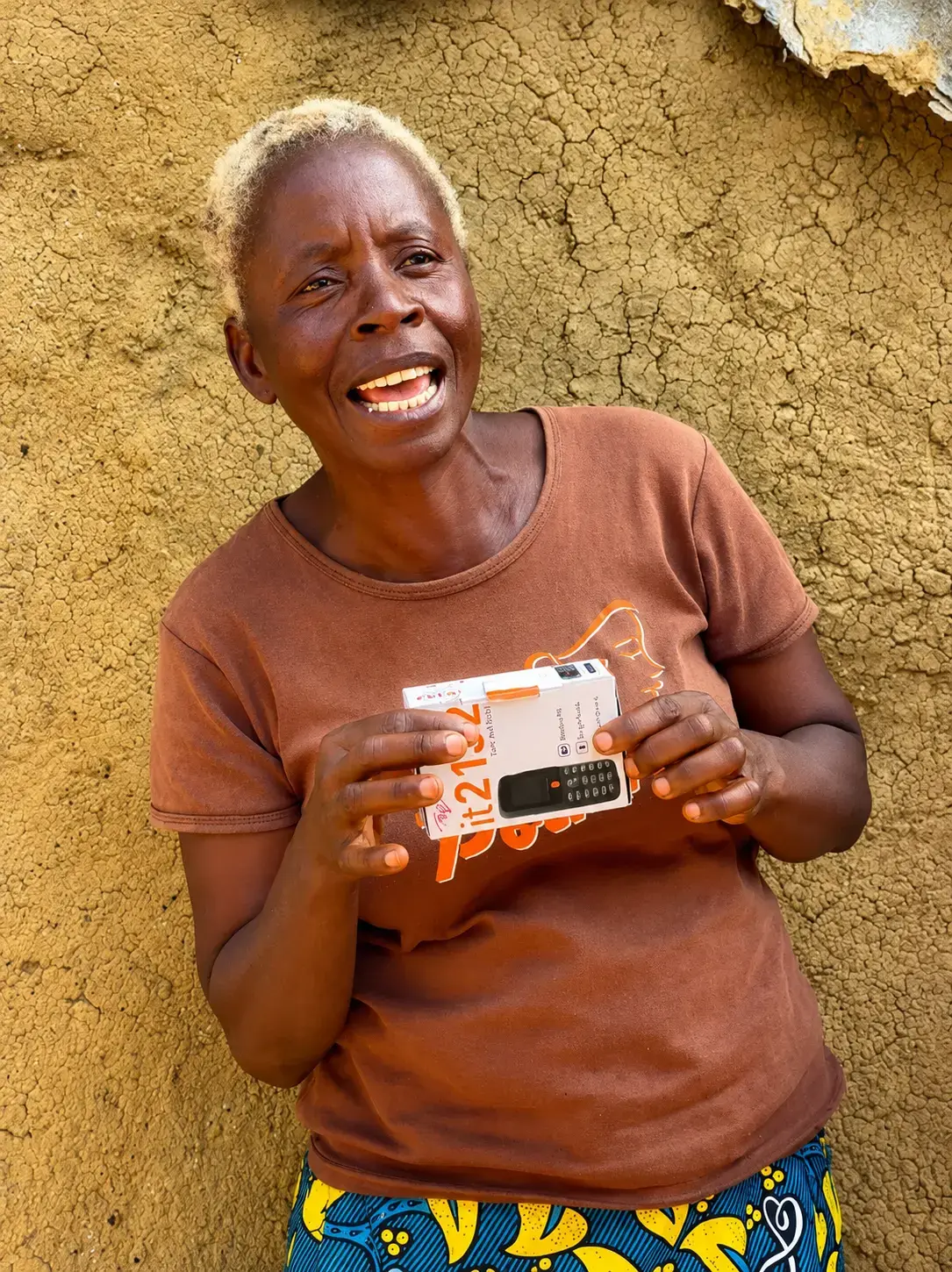Ma Nowai Kaine of Sargent Kollie Town, Bong County, Liberia, holds the mobile phone she received through the D4WEE Project, enabling her to independently manage mobile money transactions. Photo: UN Women Liberia/Aisha Kolubah.