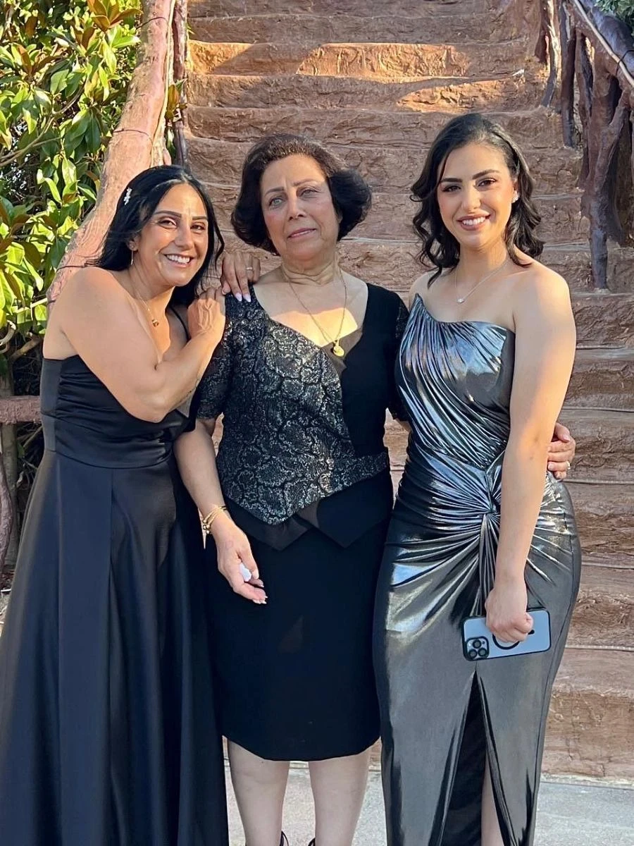 Three generations of women pose together on a special occassion